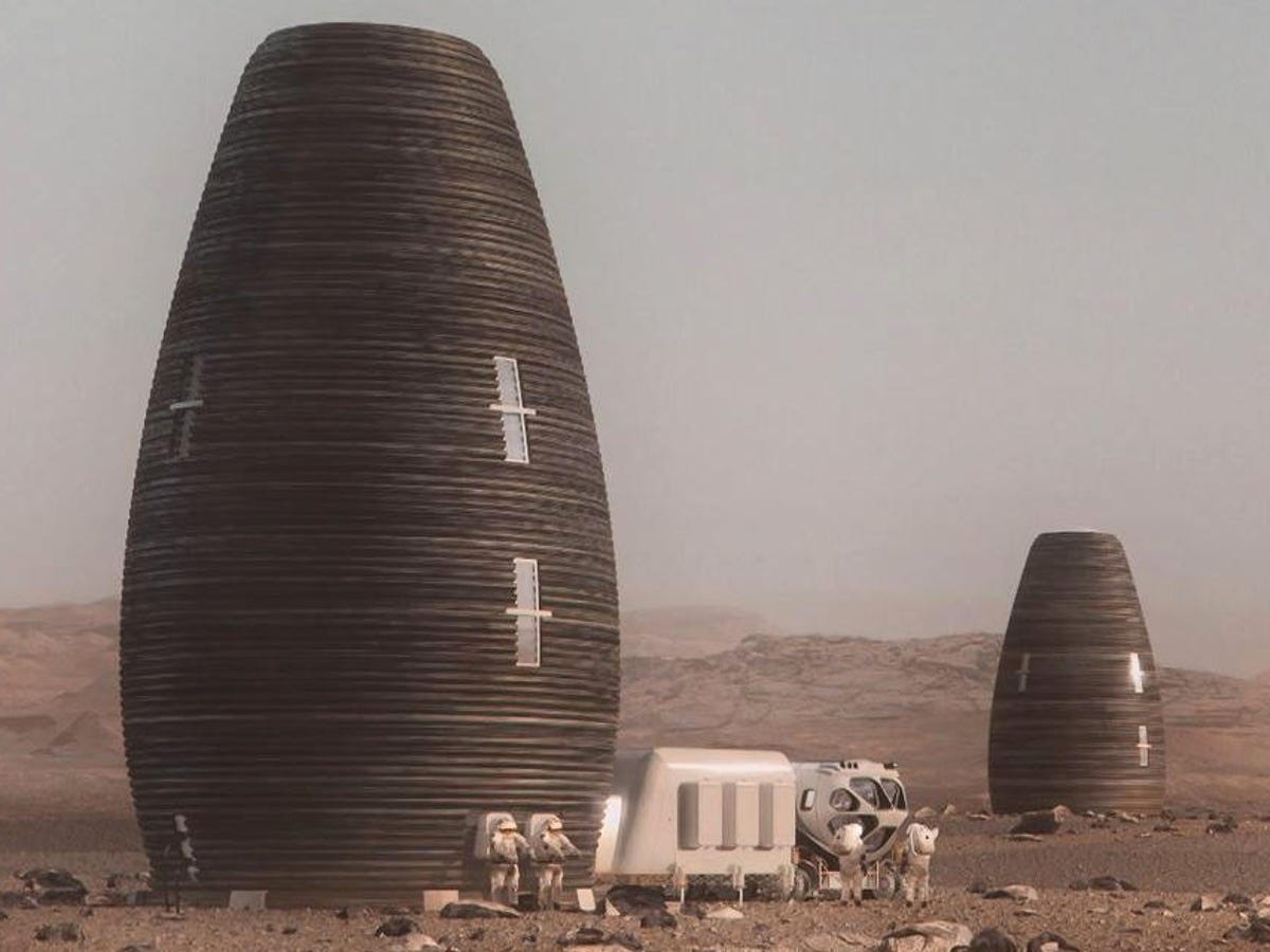 Concept rendering of two tall habitat structures in an off-Earth landscape